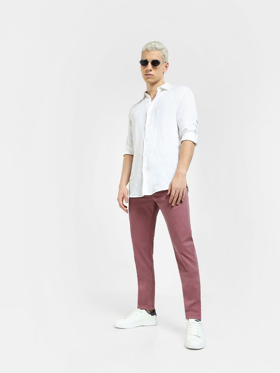 Premium Photo | Handsome young man in white shirt and pink pants on pink  background
