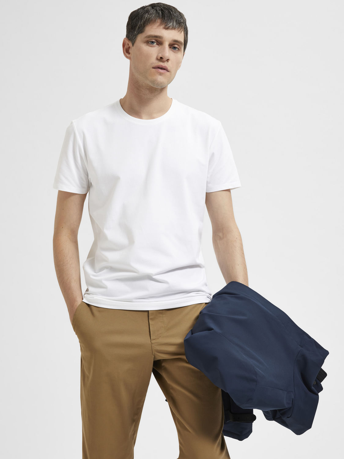 Man in White Tshirt and Brown Pants Wearing White Cap  Free Stock Photo